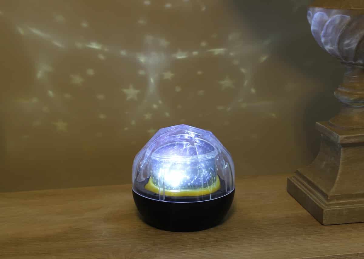 decorative star projector on kids bedroom table